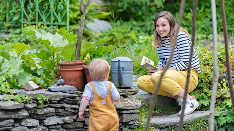 Mother and son in the garden at Hill Top, Near Sawrey, Lake District